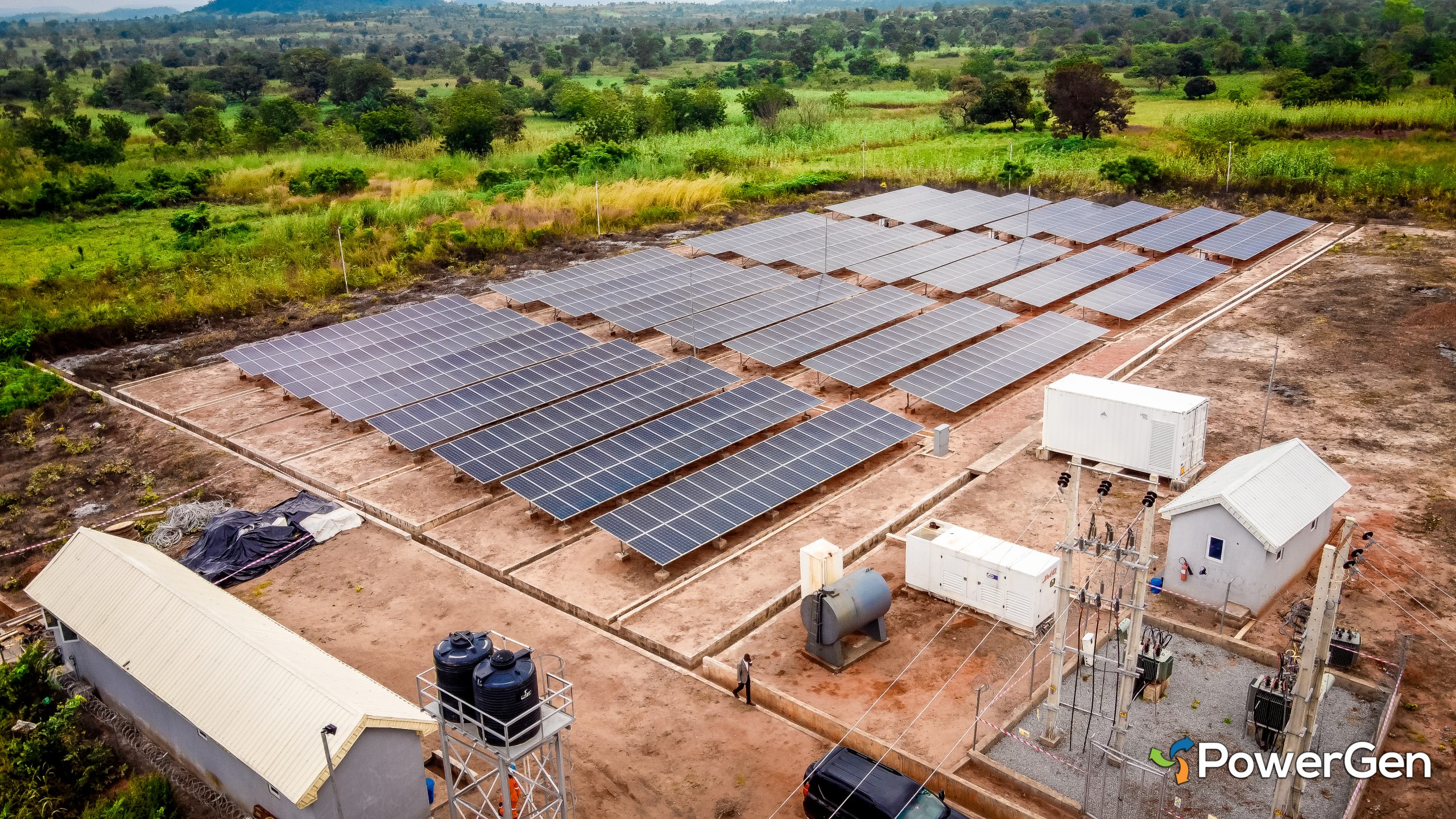 Aerial view of a solar power installation with multiple solar panels arranged in rows